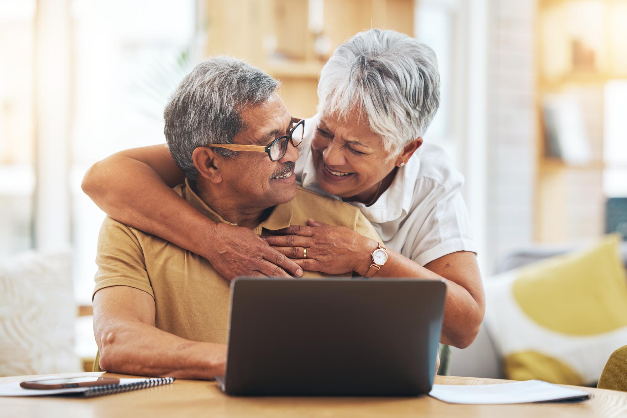 2 senior couple embrace